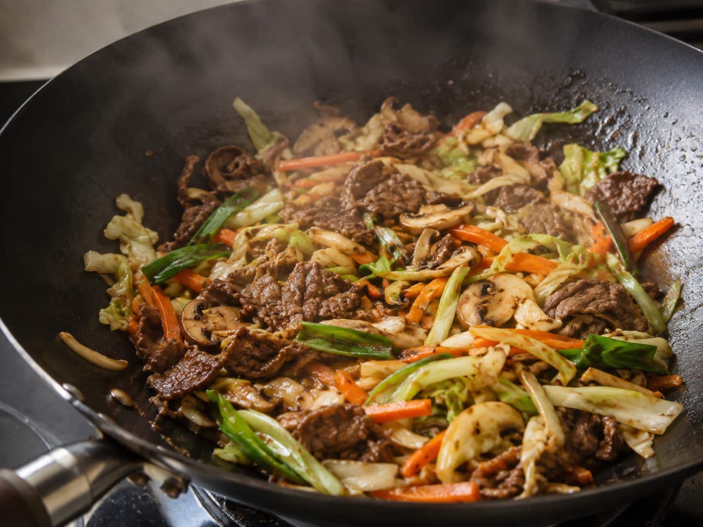 Moo shu beef and vegetables cooking in a wok