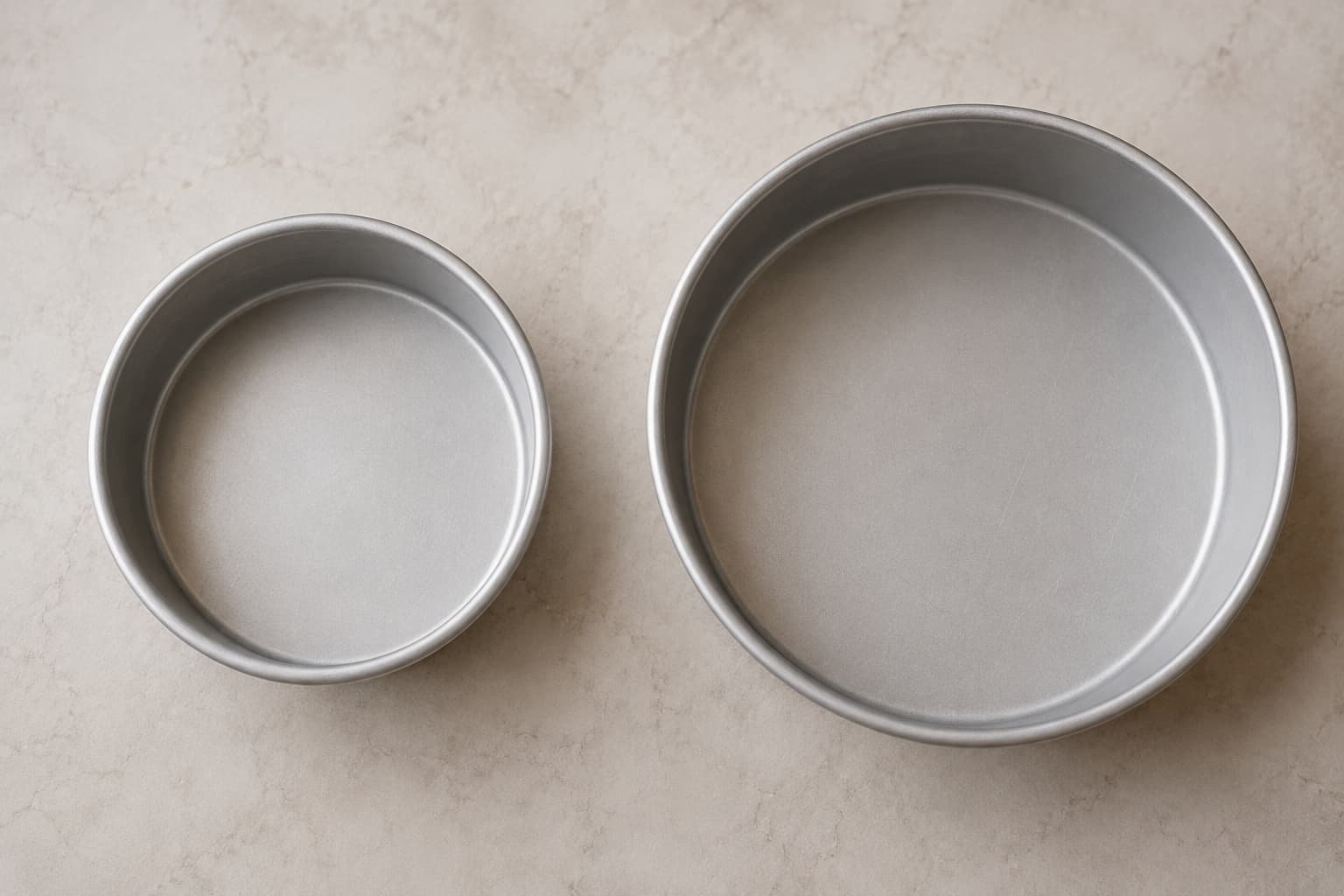 Side-by-side comparison of smaller and larger round cake pans