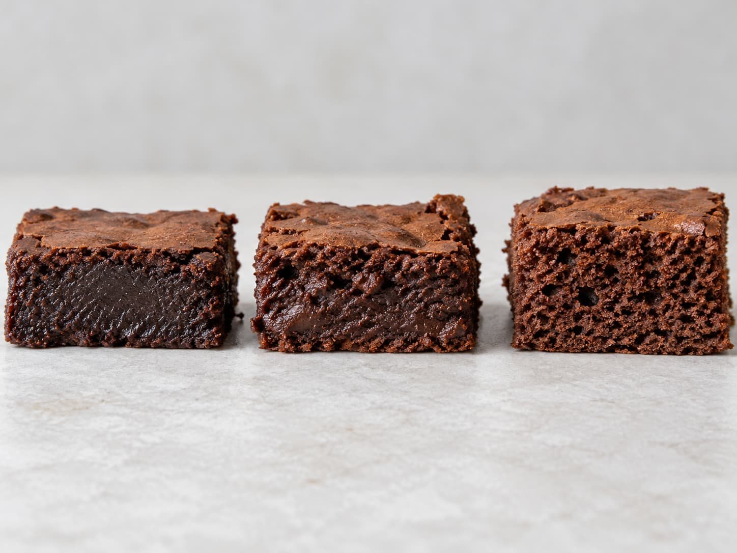 Fudgy, chewy, and cakey brownie textures shown side by side